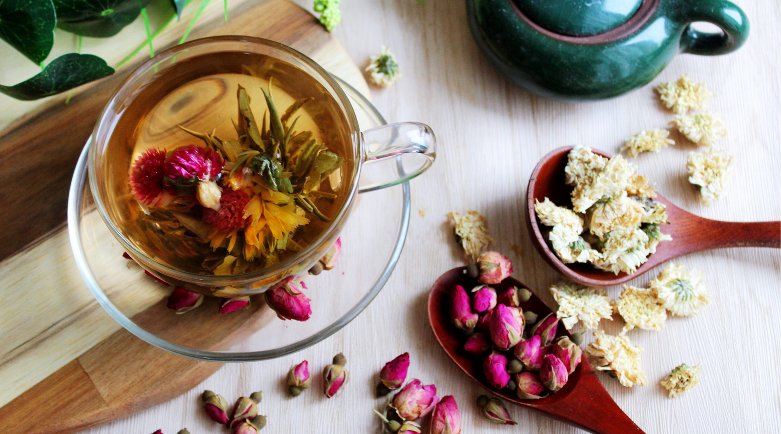 "Glass tea cup with green blooming tea and herbs for a mindful tea ritual